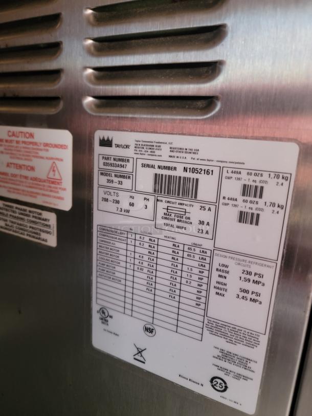 Taylor commercial freezer label showing model 359-33, serial N1052161, voltage 208-230, and cooling specs.