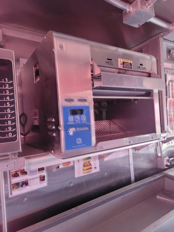 Antunes commercial toaster in stainless steel, with digital controls and labels indicating "Heel" and "Crown." Appears in good condition.