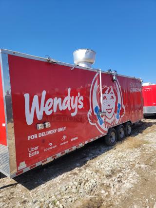 Red Wendy's food trailer with three axles, featuring branding and delivery service logos. Used condition, dent on roof vent.