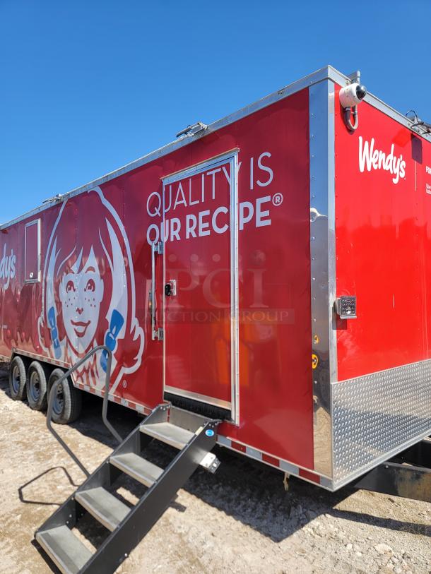 Red Wendy's mobile trailer with staircase, featuring logo and "Quality is Our Recipe" slogan. Good condition.
