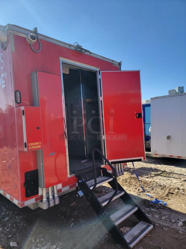 Red mobile unit with open door and steps, revealing interior. Tags indicate 120/208V, 3-phase electrical setup.