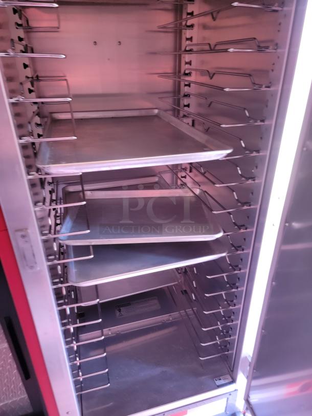 Commercial metal food storage rack with multiple slide-in trays; clean and well-maintained condition.
