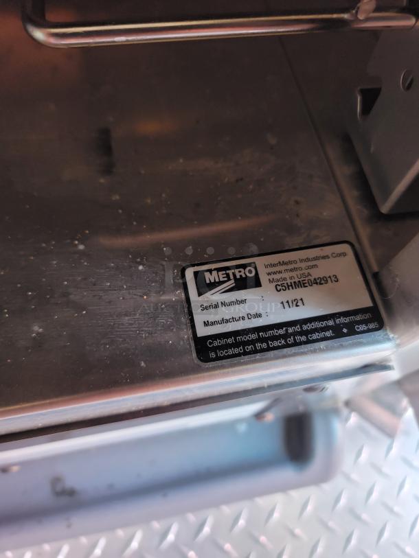 Metal cabinet by Metro, with visible label showing serial number C5HME042913 and manufacture date 11/21.