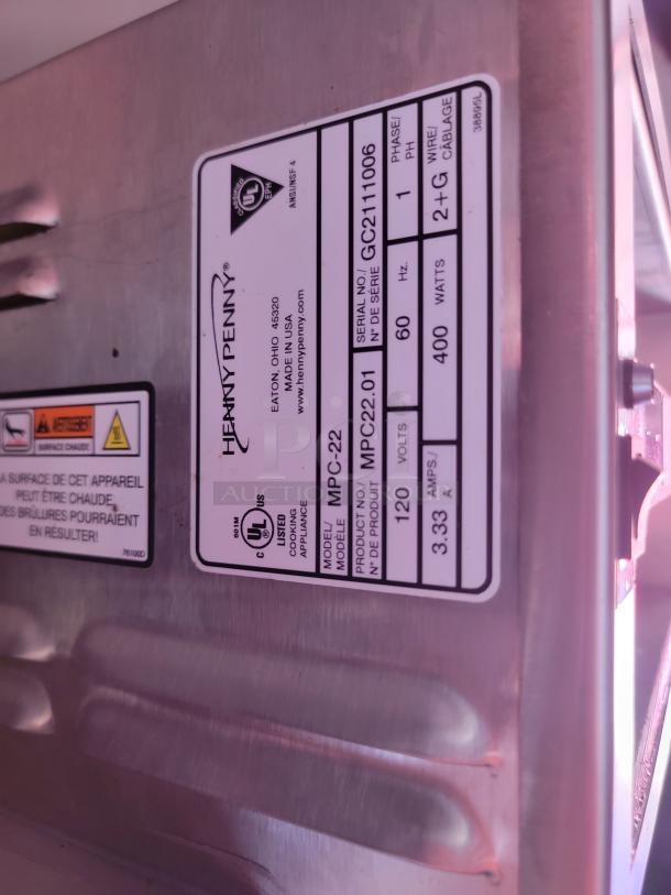 Henny Penny label showing model MPC-22, serial GC2111006, 120V, 400W, made in USA. Stainless steel appliance.
