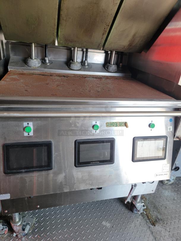 Commercial kitchen griddle with stainless steel finish, three green push buttons, and two digital displays. Brand: Garland. Used condition.