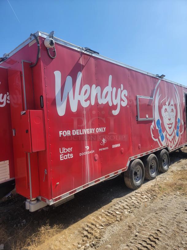Red Wendy's food trailer, marked for delivery only with logos of Uber Eats, DoorDash, Postmates, Grubhub. Tracked on three axles.