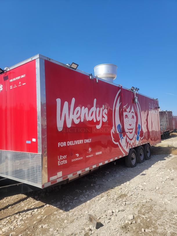 Red Wendy's delivery-only trailer with logo and partner delivery services: Uber Eats, DoorDash, Postmates, Grubhub. Triple axle.
