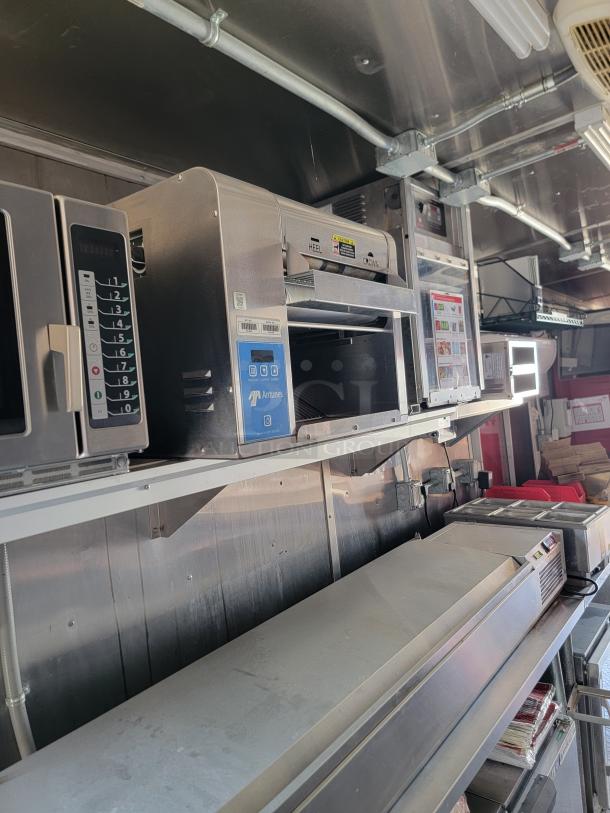 Commercial kitchen equipment setup featuring an Antunes toaster with digital controls, excellent condition.