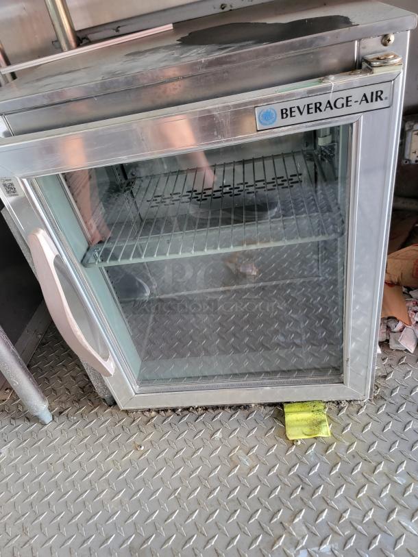 Beverage-Air stainless steel display cooler with glass door, two shelves, and side handle. Visible logo on front. Appears used.