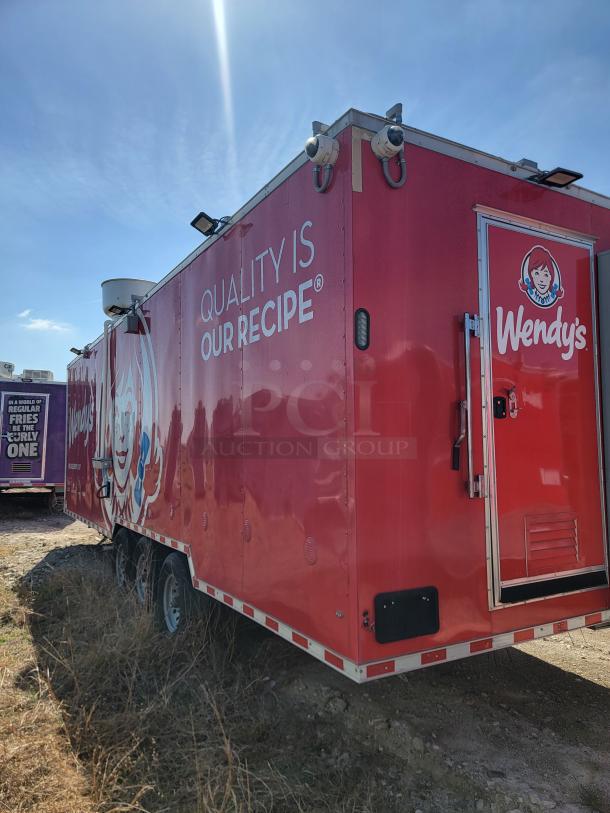 Red Wendy's food truck with brand logos and "Quality Is Our Recipe" text. Visible cameras and ventilation on roof. Appears in good condition.
