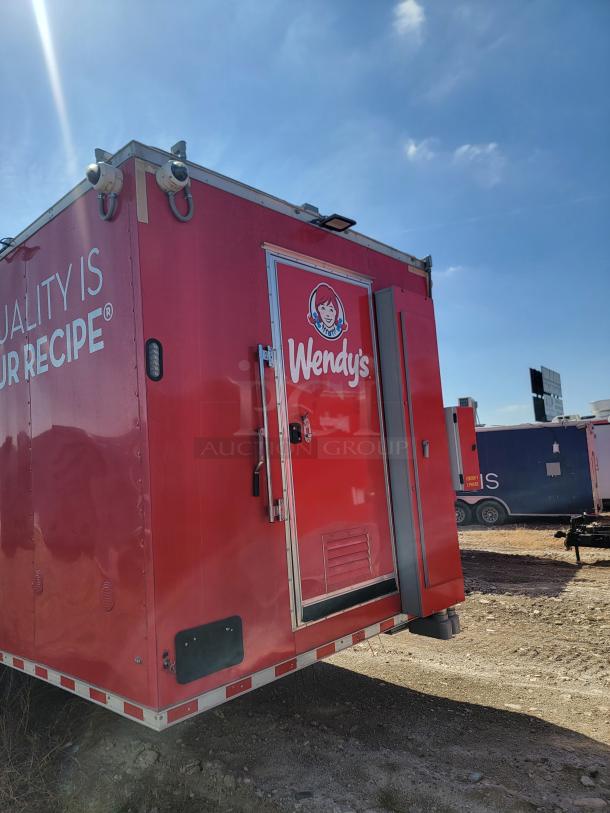 Red Wendy's food trailer with logo and "Quality Is Our Recipe" text, visible in outdoor setting.
