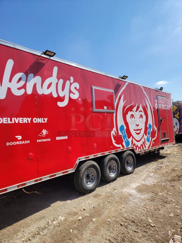 Red Wendy's food truck with logo, three axles, featuring delivery service brands like DoorDash, Postmates, Grubhub.