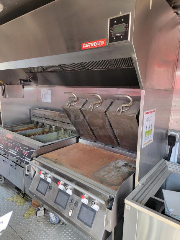CaptiveAire commercial kitchen hood system, includes fryer and grill. Stainless steel, digital controls, used condition.