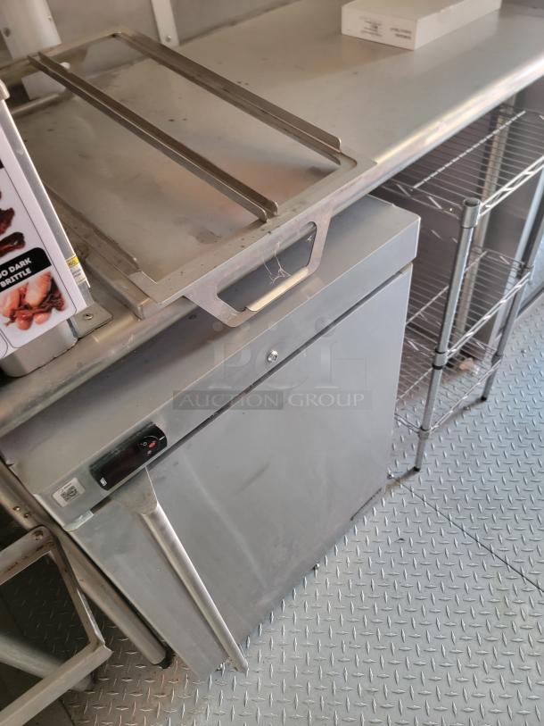 Commercial stainless steel undercounter refrigerator, features push-door handle and temperature control; good condition.