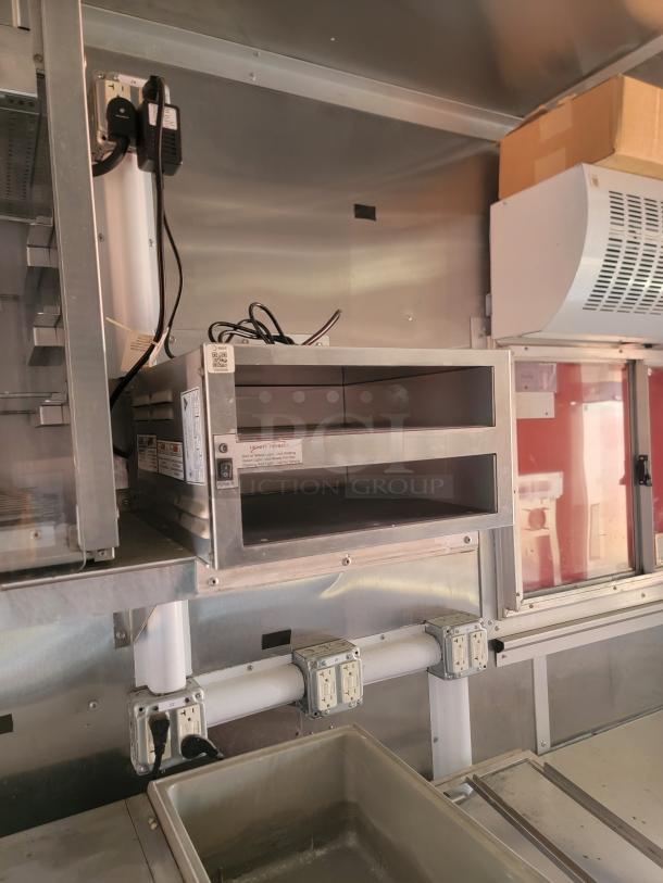 Commercial stainless steel food warmer, dual compartments, Mount with visible power outlets, used condition.
