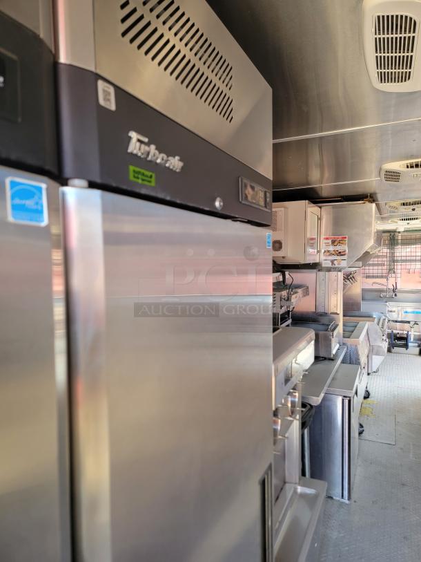 Stainless steel Turbo Air fridge in commercial kitchen. Features digital display and Energy Star label. Excellent condition.