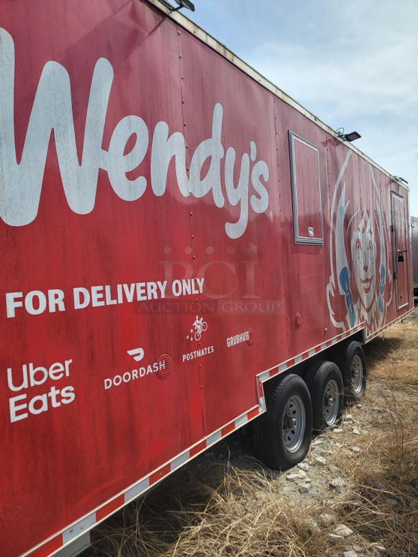 Red Wendy's delivery trailer with logo and food delivery service logos: Uber Eats, DoorDash, Postmates, Grubhub.