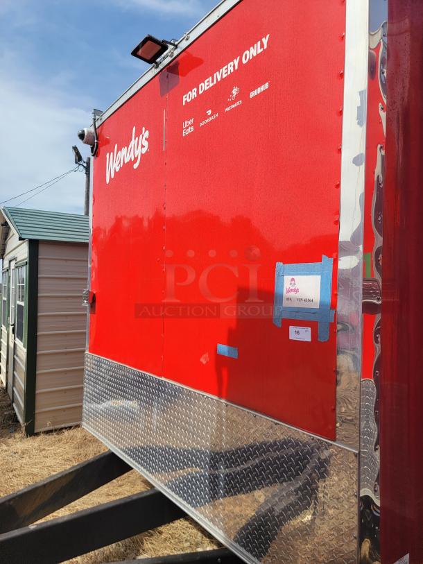 Red Wendy's delivery trailer with "For Delivery Only" signage, logos for Uber Eats, DoorDash, and Grubhub. Metal diamond plate trim.