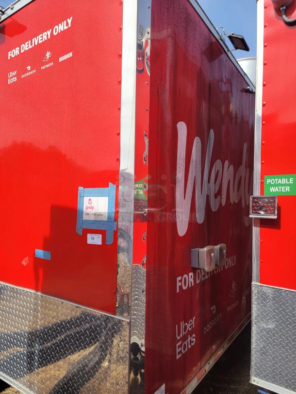 Red food delivery trailer with Wendy's branding, marked "For Delivery Only" with service logos; features diamond plate detail and potable water sign.