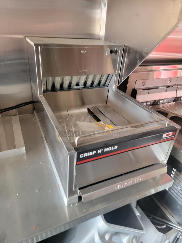 Hatco Crisp N' Hold warming station in stainless steel, featuring a spacious open bin. Marked "Caution Hot." Excellent condition.