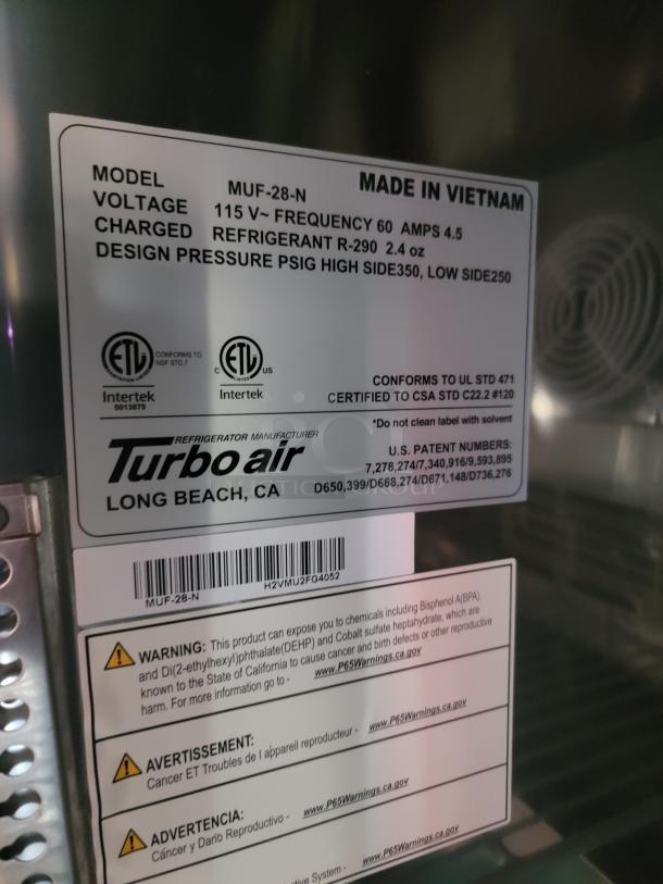 Turbo Air MUF-28-N model label showing voltage, refrigerant type, and pressure specs. Made in Vietnam. Safety warnings included.
