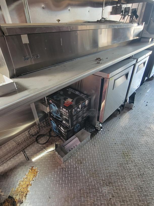 Stainless steel Turbo Air freezer unit with visible minor wear, featuring dual compartments and sturdy construction.