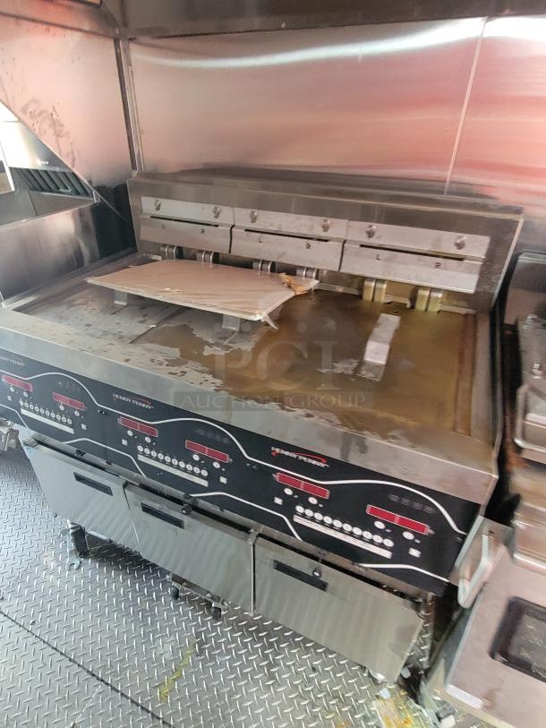 Commercial griddle with dual temperature control panels, used condition, featuring adjustable cooking surfaces and metal construction, ideal for restaurant settings.