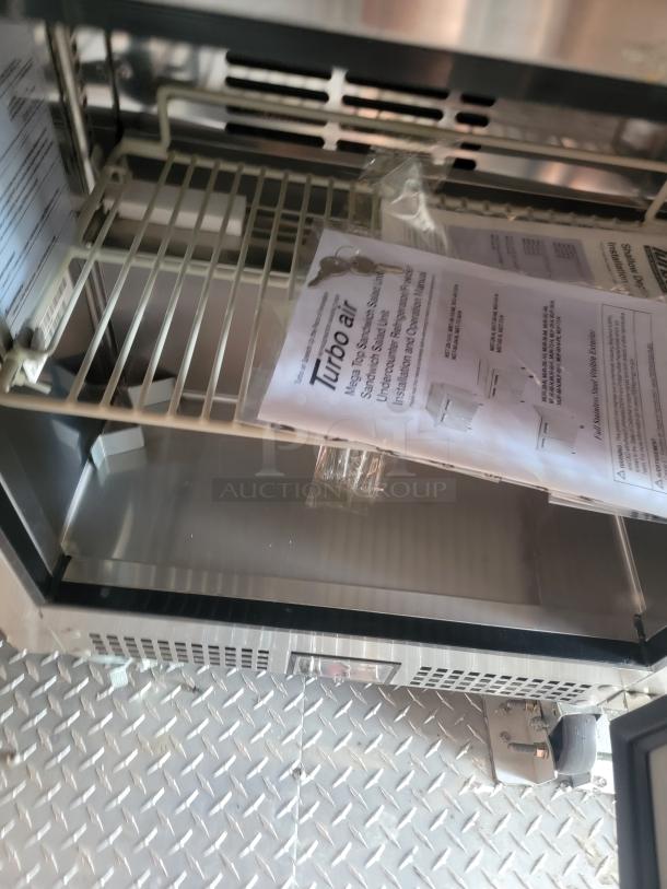 Turbo Air sandwich prep refrigerator, metal shelving, includes installation and operation manual, new condition.