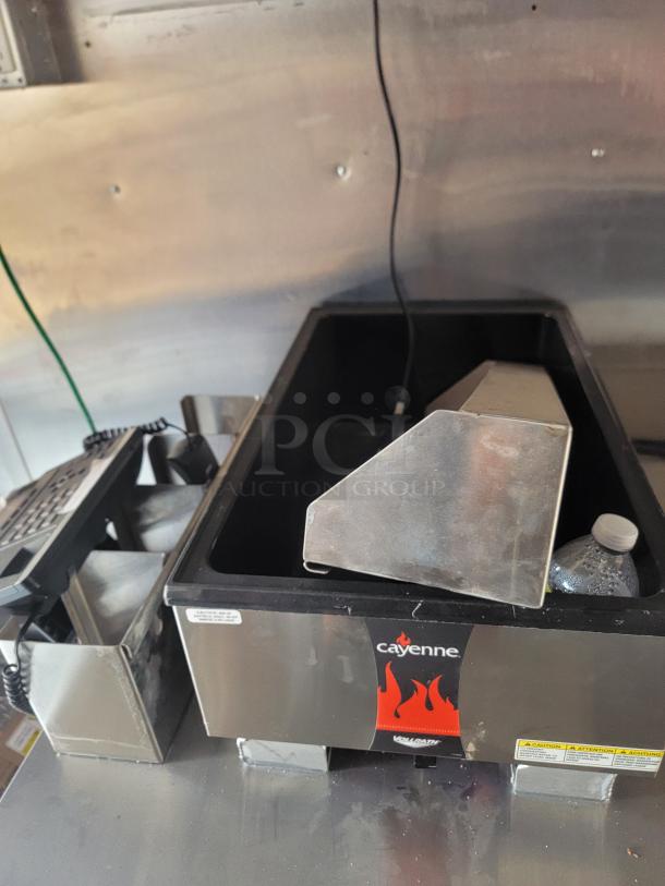 Vollrath Cayenne heated food well in stainless steel, used condition. Features flame logo and caution labels.