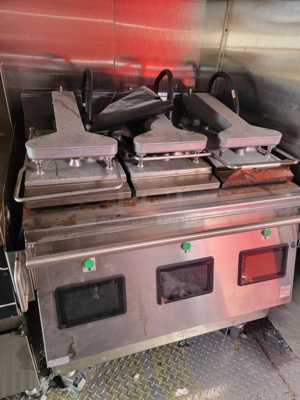 Commercial sandwich press with three adjustable metal plates, stainless steel exterior, green control buttons, used condition.