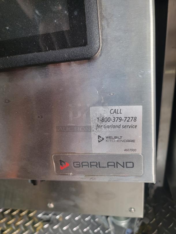 Garland kitchen appliance with a label for Welbilt KitchenCare service and contact number; stainless steel exterior, model 4607900.
