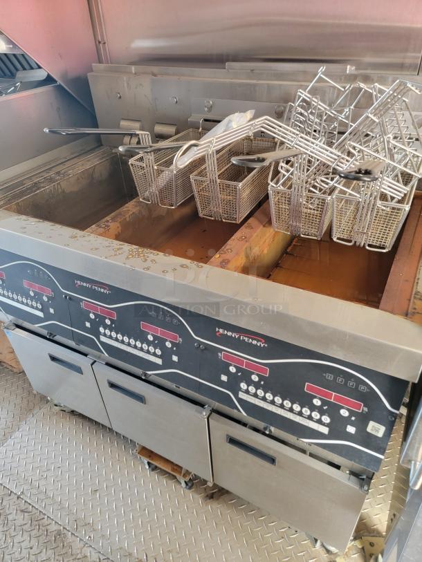 Henny Penny commercial deep fryer with multiple baskets, stainless steel, digital controls, used condition.