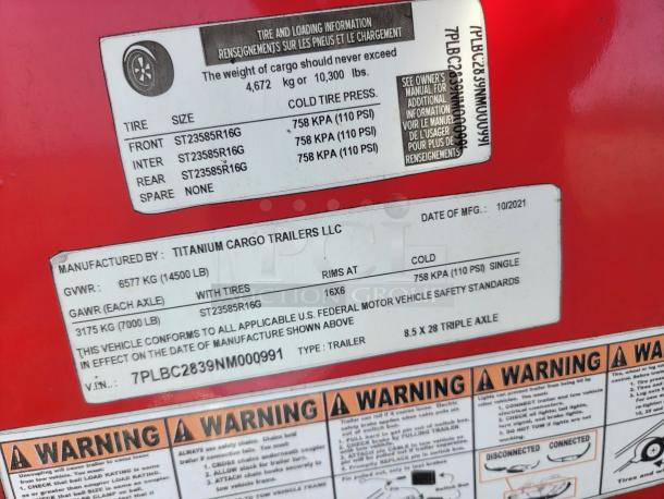 Label on a red Titanium Cargo Trailer displaying tire specs, GVWR 6577 kg, GAWR 3175 kg, manufactured 10/2021, VIN 7PLBC2839NM000991.