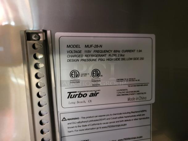 Turbo Air model MUF-28-N label showing voltage 115V, frequency 60Hz, current 1.9A, refrigerant R-290, and design pressure details.
