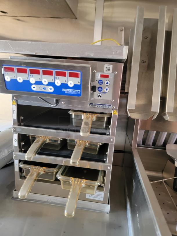Prince Castle hot holding unit with multiple slots and digital display, includes clear handled pans. Stainless steel, excellent condition.
