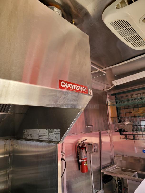 CaptiveAire stainless steel kitchen hood, commercial grade, with visible model label and safety instructions, in excellent condition.