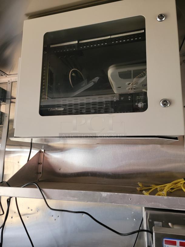 CyberPower wall-mounted server rack with visible networking equipment. Model PS Series. Used condition.