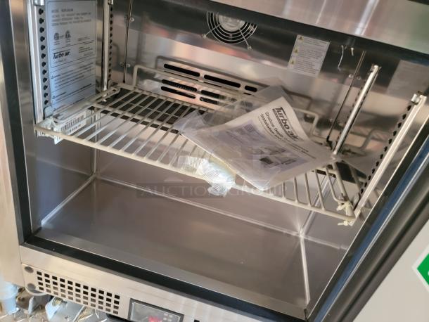Turbo Air commercial refrigerator inner view, model MUR-36-N6. Includes instruction manual and adjustable wire shelf.