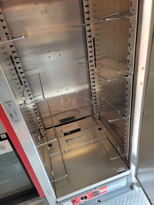 Commercial heated holding cabinet with adjustable shelves, stainless steel interior, visible control panel, adjustable racks.