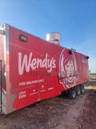 Red Wendy's food trailer with delivery service logos. Features include visible exhaust fan and three axles. Condition shows wear. No VIN.