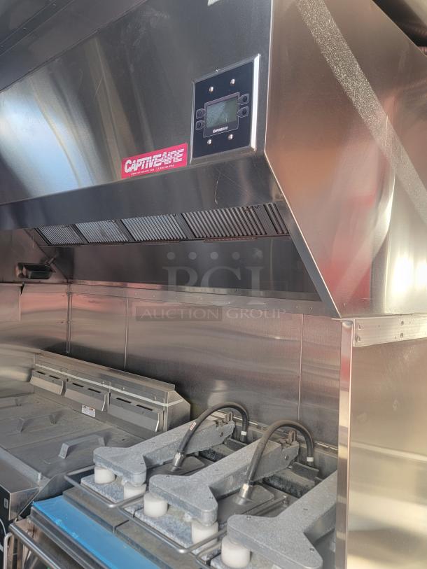 CaptiveAire stainless steel kitchen exhaust hood with control panel, pristine condition, features advanced filtration system.