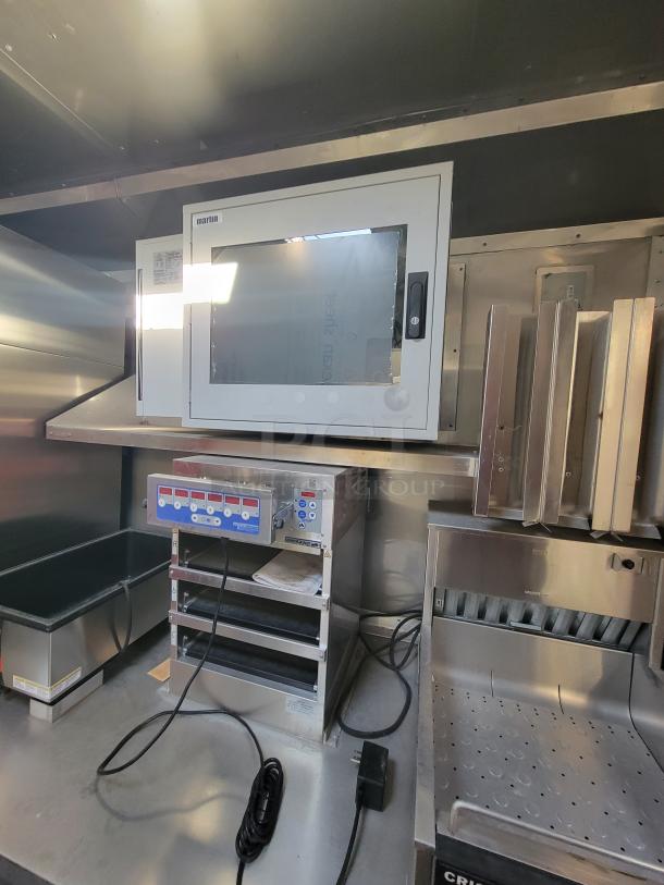 Commercial kitchen equipment with Martin oven, stainless steel construction, digital controls, and cable connections, in good condition.
