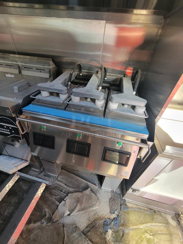 Commercial kitchen equipment with two sandwich presses, stainless steel finish, three control panels, and buttons visible.
