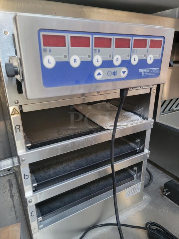 Prince Castle food transfer cabinet, includes three shelves and digital controls. Slight markings visible, overall good condition.