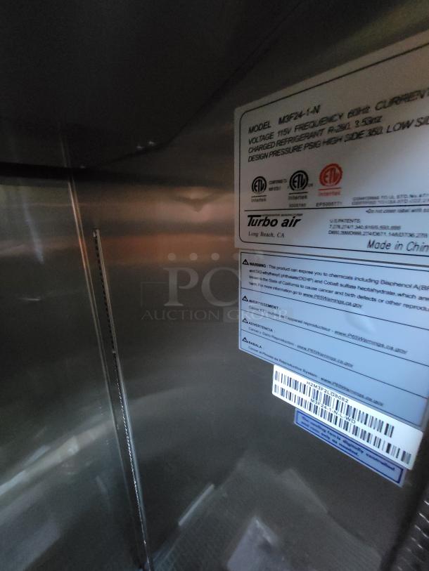 Turbo Air model M3F24-1-N refrigerator label. Shows specifications, certifications, and barcode. Stainless steel interior.