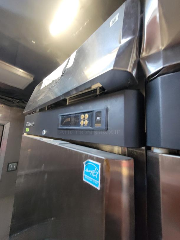 Stainless steel commercial refrigerator with digital controls, Energy Star label, and minor dents.