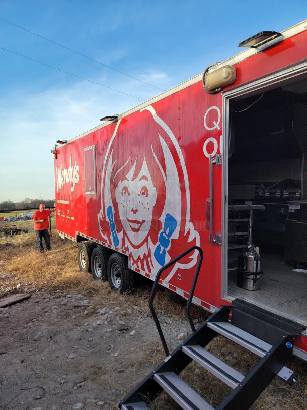 Wendy's branded red food trailer with stairs, featuring company logo. Good condition, equipped for mobile food service.