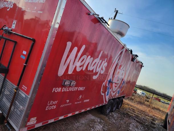 Red Wendy's delivery trailer with logo, featuring Uber Eats, DoorDash, Postmates, Grubhub branding. Three axles, outdoor setting.