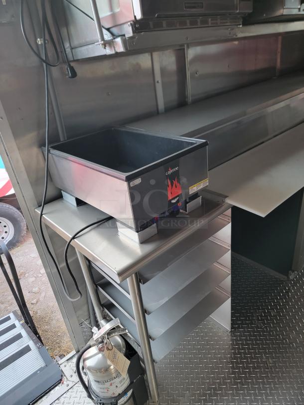 Countertop food warmer by Cayenne, stainless steel, plug-in design, digital controls, includes shelf and extinguisher.