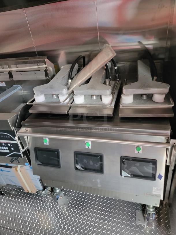Stainless steel commercial kitchen equipment on wheels, featuring dual controls and sturdy metallic build. Excellent condition.